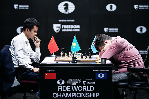 Ding Liren (left) wins the pivotal Game 12 after a meltdown by the devastated Ian Nepomniatchi (right)